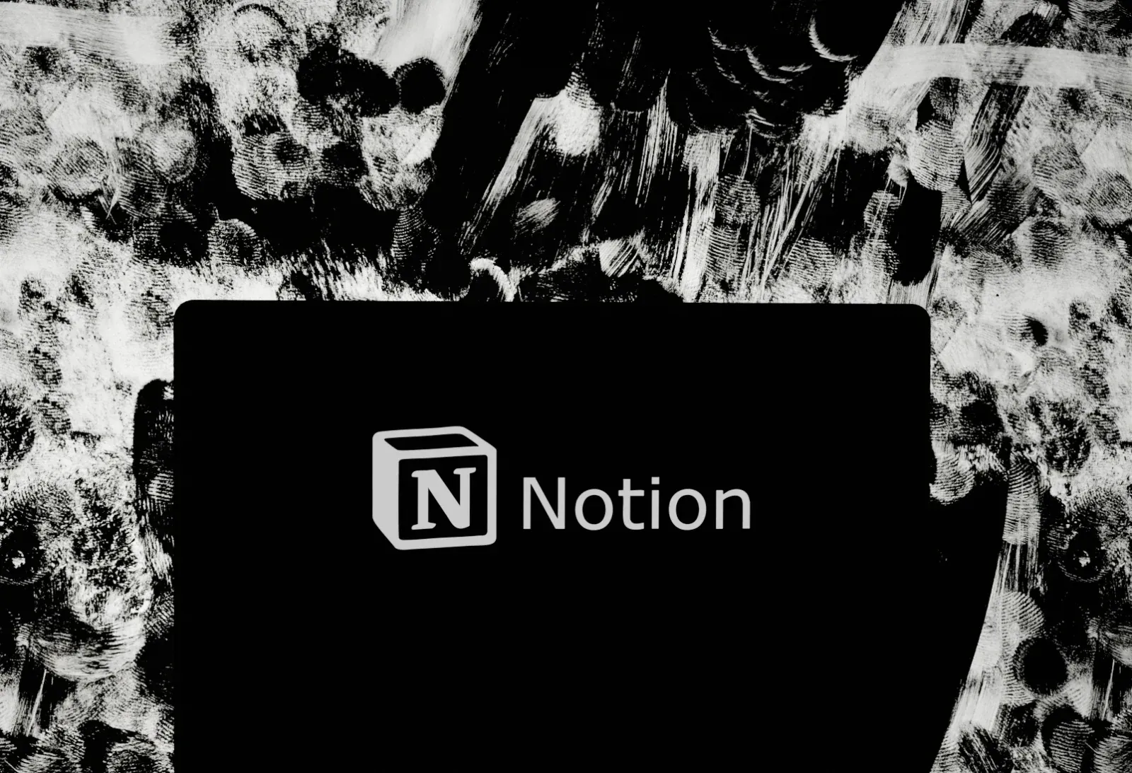 Laptop showing the Notion logo, the portal clients use to follow each project