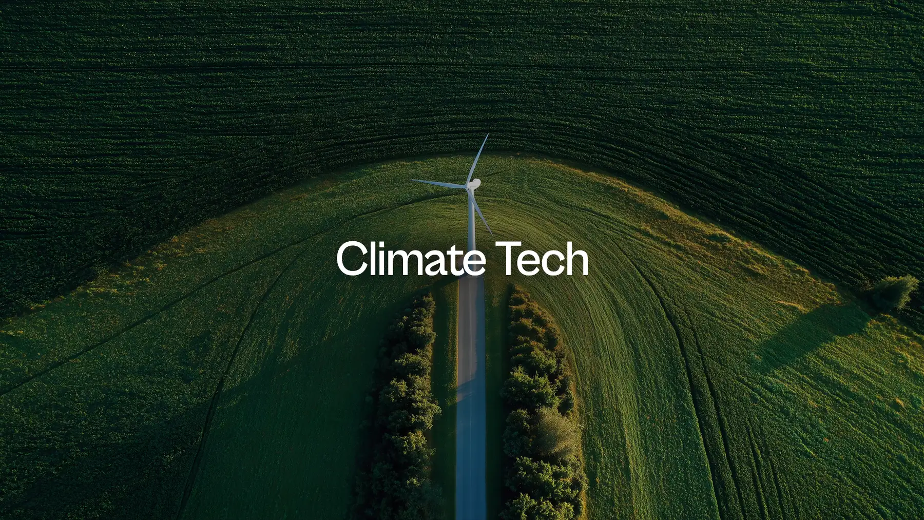 Climate Tech: a wind turbine alone in a sunlit field, seen from above