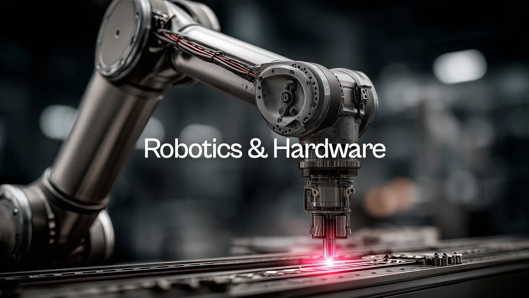 Robotics & Hardware: an industrial robot arm cutting along an assembly line